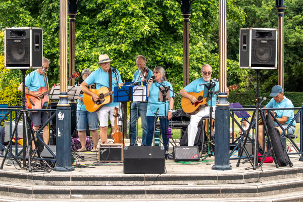A group of people playing musical instruments in a band stand